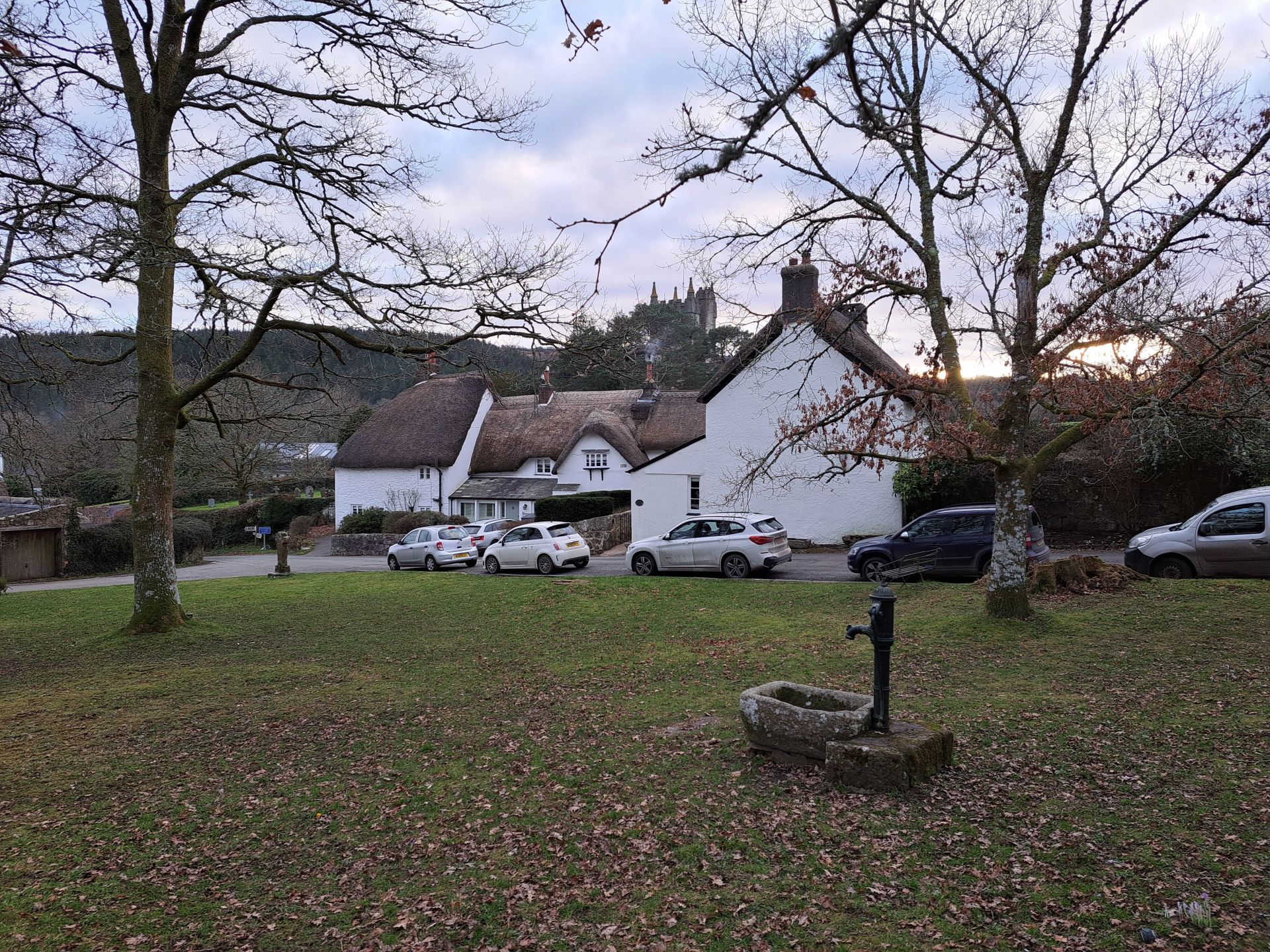 Village Green North Bovey with church tower peeking over thatched roofs